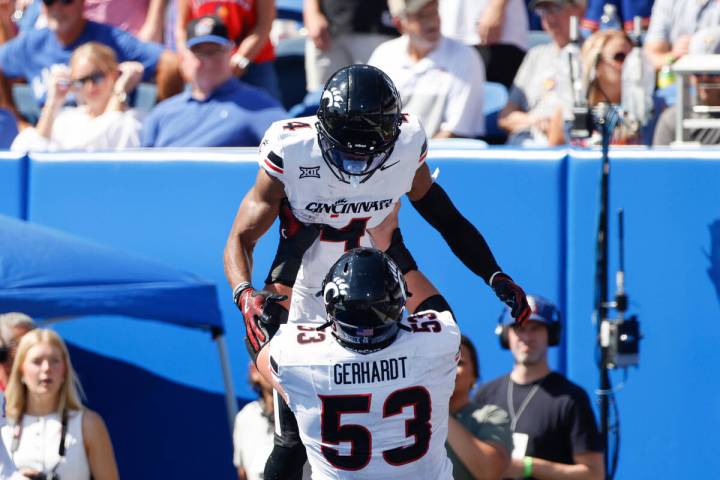 Cincinnati wide receiver Cyrus Allen (4) celebrates scoring a touchdown with offensive lineman ...