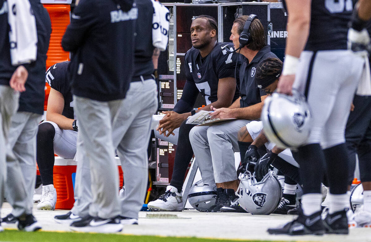 Raiders quarterback Geno Smith (7) talks with quarterback's coach Greg Olson on the bench ...