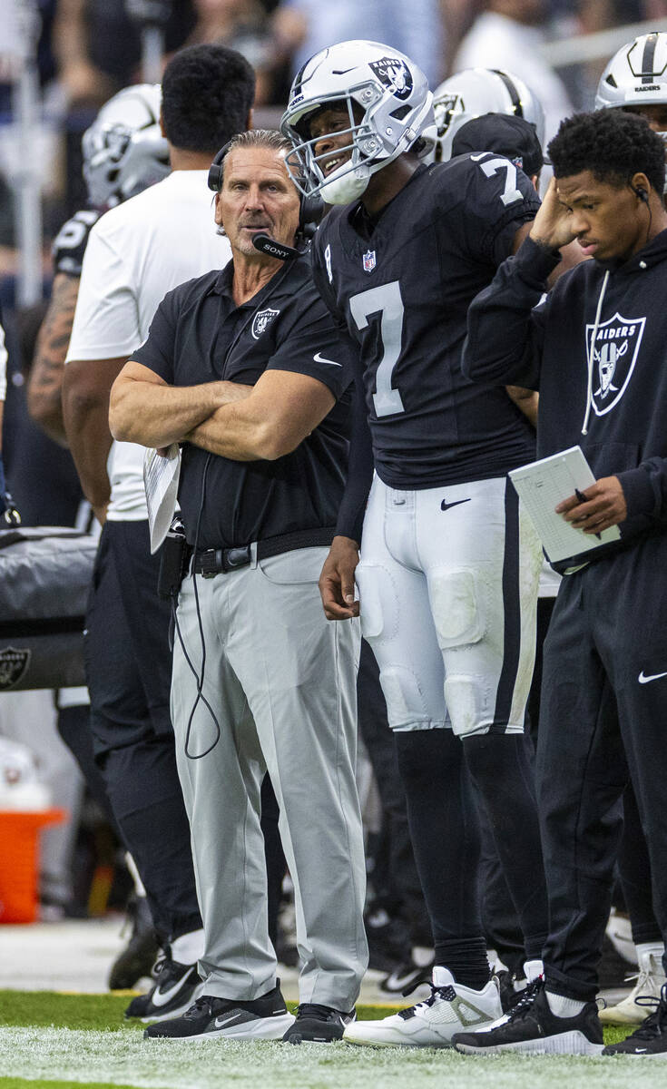 Raiders quarterback Geno Smith (7) smiles beside quarterback's coach Greg Olson after a sc ...