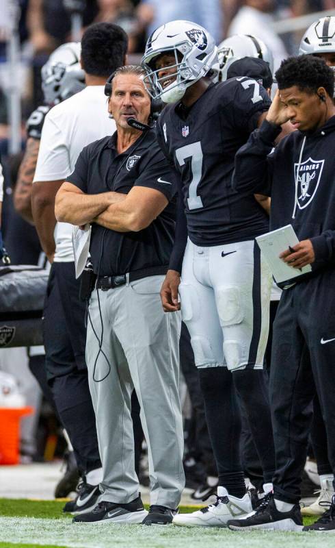 Raiders quarterback Geno Smith (7) smiles beside quarterback's coach Greg Olson after a sc ...