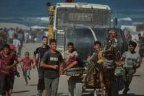 A Palestinian man injured by Israeli artillery fire targeting a group of civilians fleeing from ...