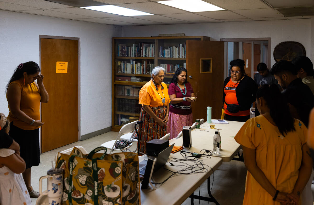 Yvonne Hawk Verjan, center, in orange, and Roberta Garcia, to her right, lead a blessing during ...