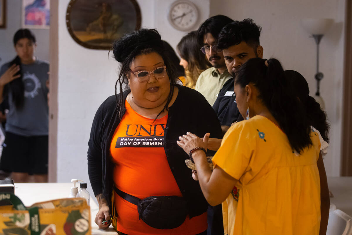 Attendees waft a cleansing smoke from Melissa Spence, of Indigenous Vision, during a gathering ...