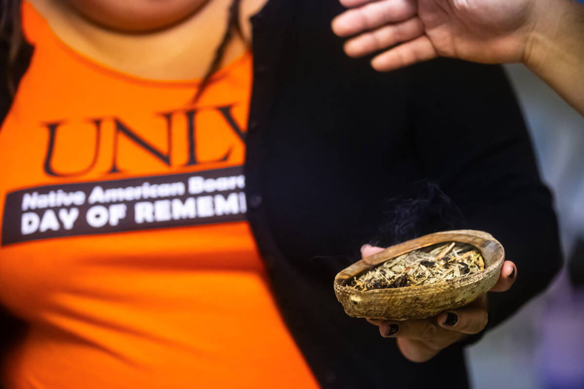 Attendees waft a cleansing smoke from Melissa Spence, of Indigenous Vision, during a gathering ...