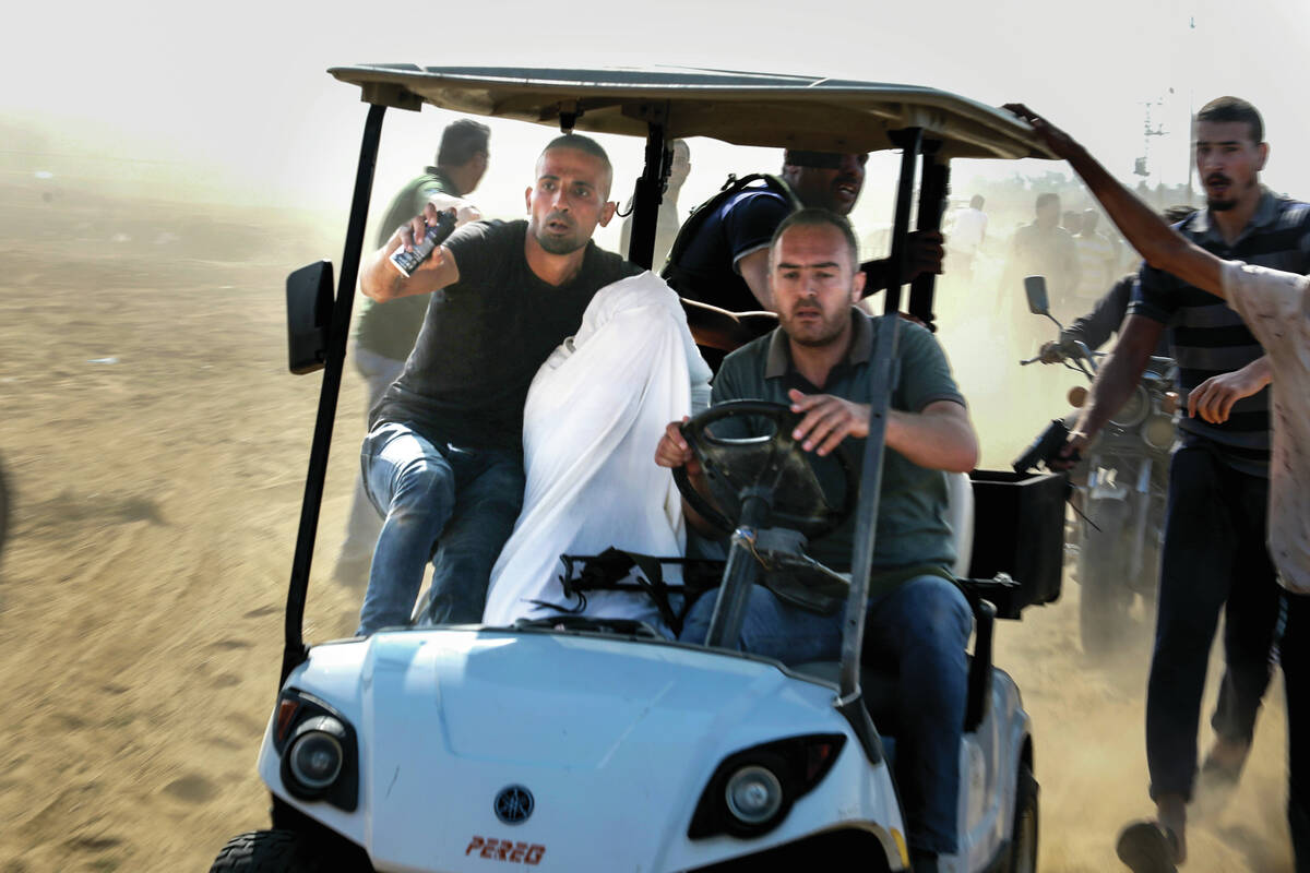 Palestinians transport a person to Gaza after kidnapping them from a kibbutz in Israel near the ...