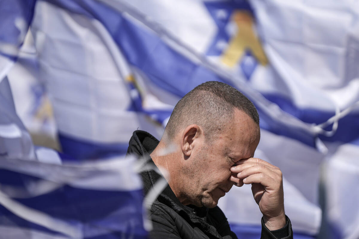 A man reacts in Hostage Square in Tel Aviv, Israel, Thursday, Feb. 20, 2025, as the remains of ...