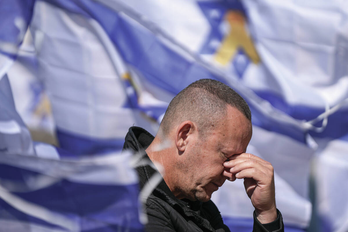 A man reacts in Hostage Square in Tel Aviv, Israel, Thursday, Feb. 20, 2025, as the remains of ...