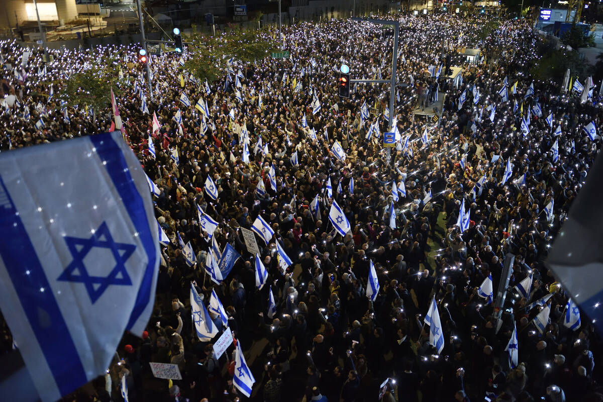 Thousands of Israelis hold up their mobile phones with flashlights turned on during a protest a ...