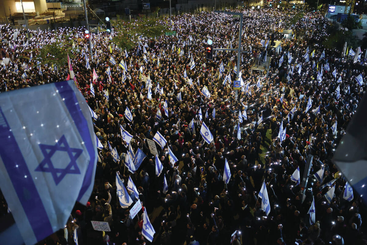 Thousands of Israelis hold up their mobile phones with flashlights turned on during a protest a ...