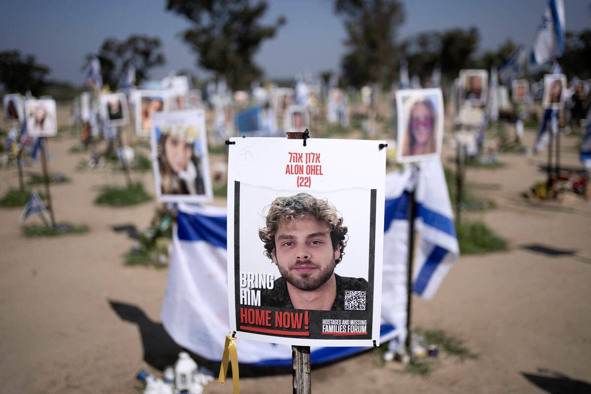 FILE - A poster depicting Israeli hostage Alon Ohel is displayed in Re'im, southern Israel ...
