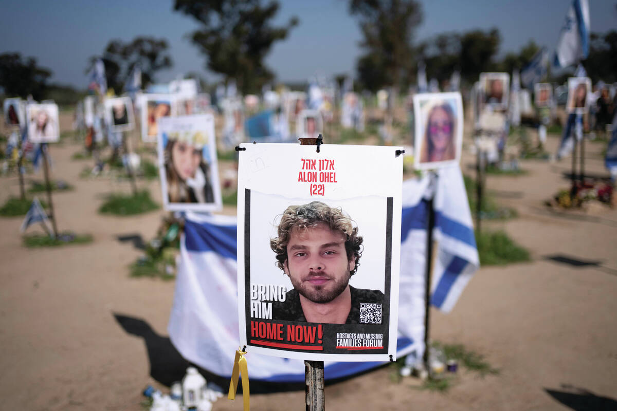 FILE - A poster depicting Israeli hostage Alon Ohel is displayed in Re'im, southern Israel ...