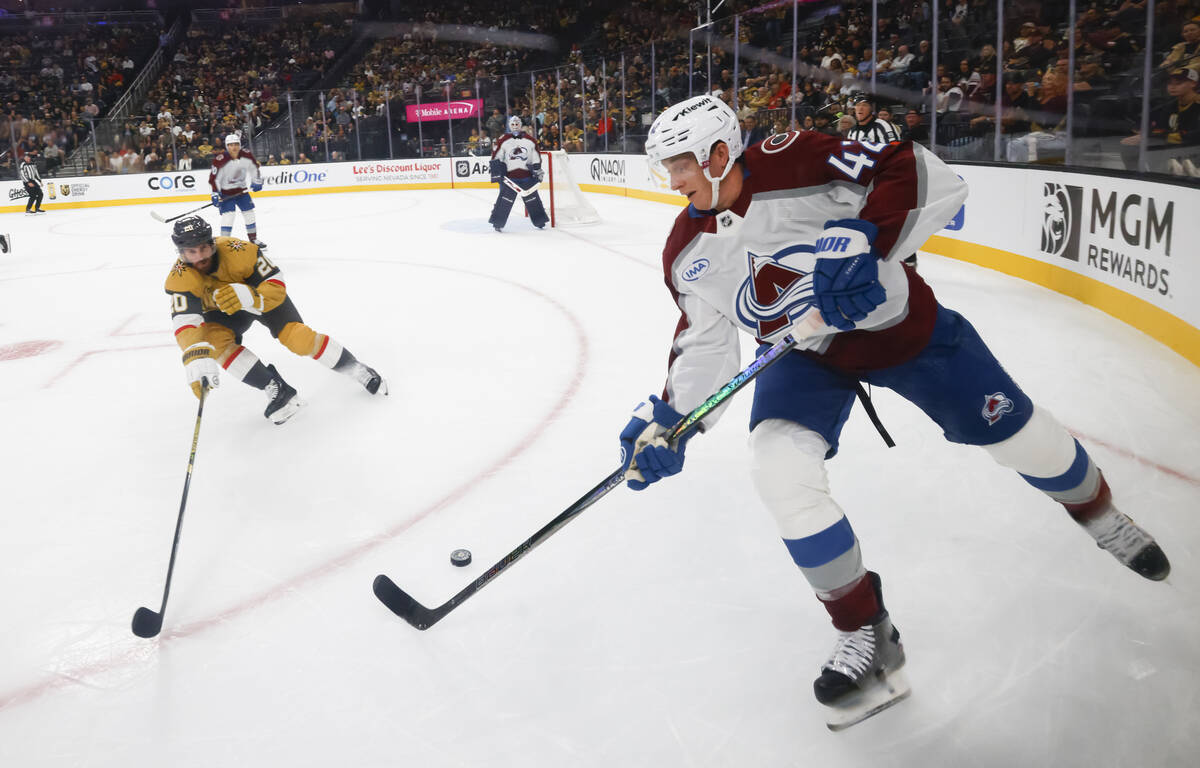 Golden Knights left wing Brandon Saad (20) tries to get the puck from Colorado Avalanche defens ...
