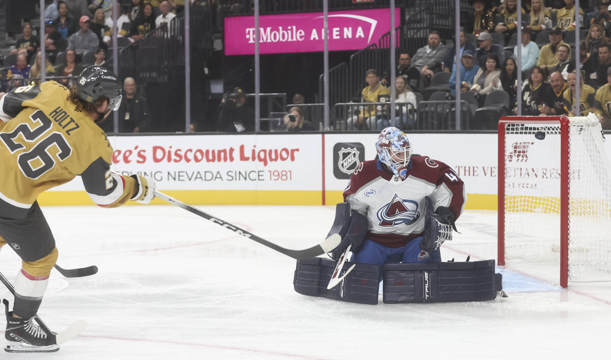 Golden Knights forward Alexander Holtz (26) shoots the puck as Colorado Avalanche goaltender Sc ...