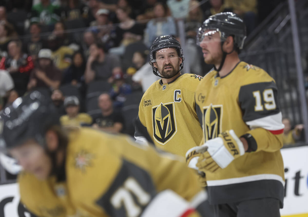 Golden Knights right wing Mark Stone, center, looks on during the second period of an NHL hocke ...