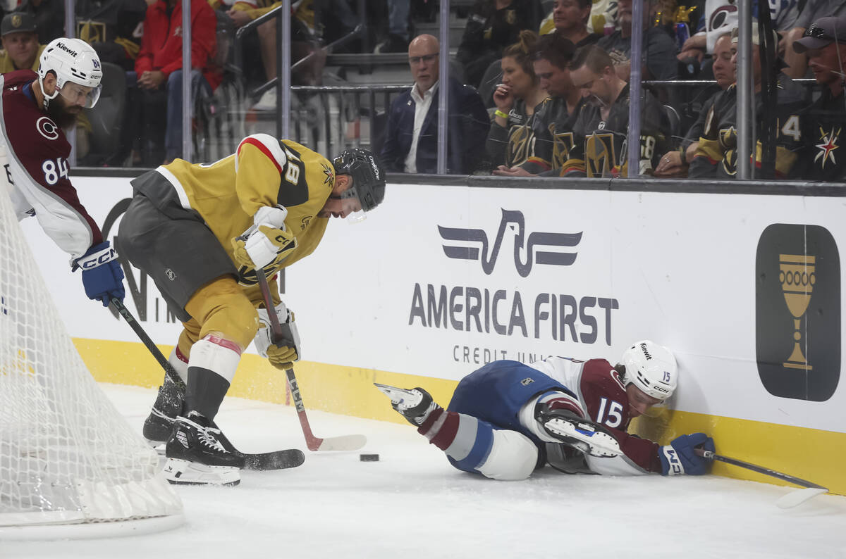 Colorado Avalanche defenseman Jack Ahcan (15) falls to the ice as Golden Knights center Tomas H ...