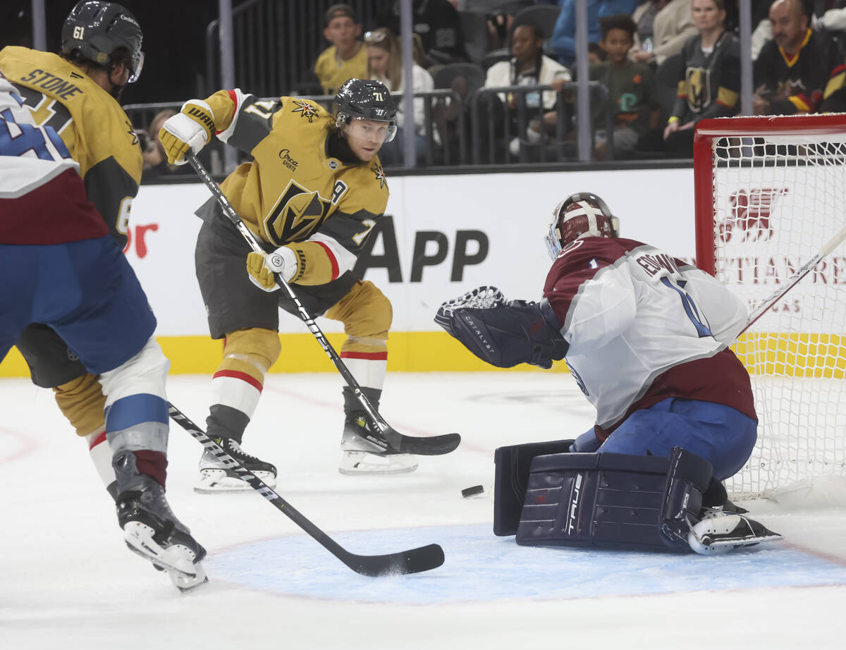 Golden Knights center William Karlsson (71) passes the puck as Colorado Avalanche goaltender Sc ...