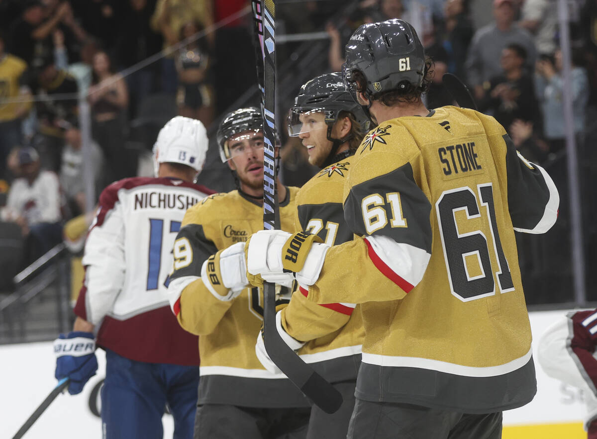 Golden Knights center William Karlsson (71) celebrates his goal with Reilly Smith (19) and Mark ...