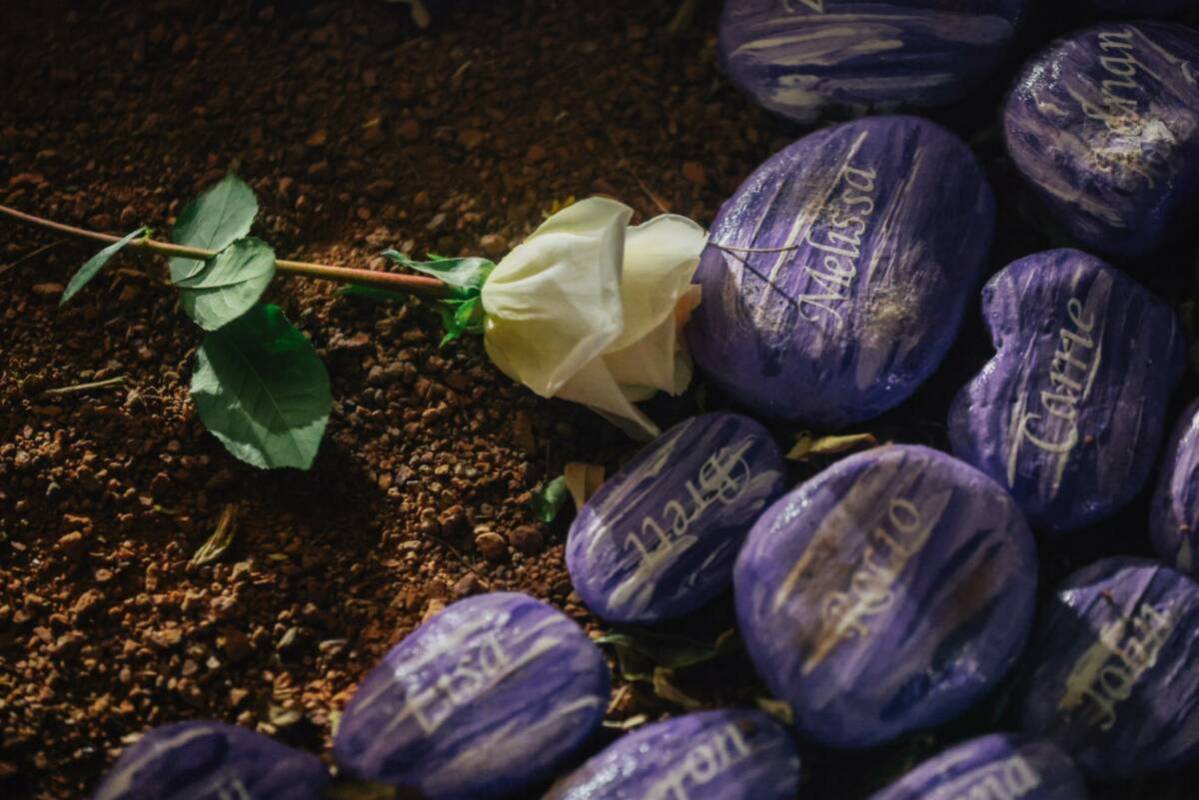 A rose is left on the ground during a ceremony in honor of the victims of the Oct. 1 shooting a ...