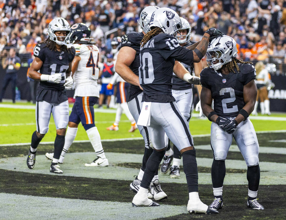 Raiders running back Ashton Jeanty (2) celebrates a touchdown with wide receiver Dont'E Th ...