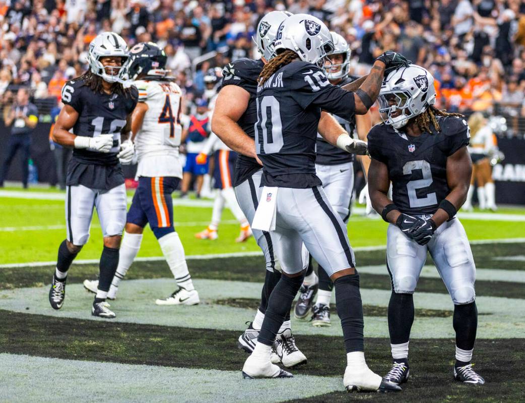 Raiders running back Ashton Jeanty (2) celebrates a touchdown with wide receiver Dont'E Th ...
