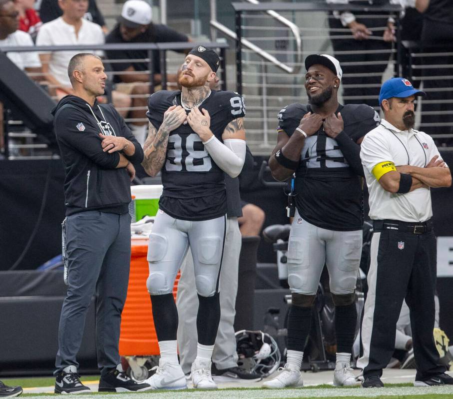 Raiders general manager John Spytek, left, meets with defensive end Maxx Crosby (98) and lineba ...