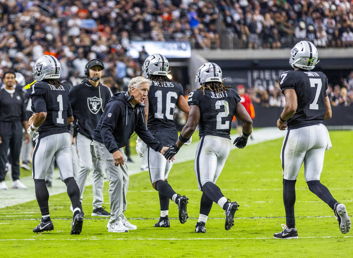 Raiders head coach Pete Carroll congratulates running back Ashton Jeanty (2) on a touchdown run ...
