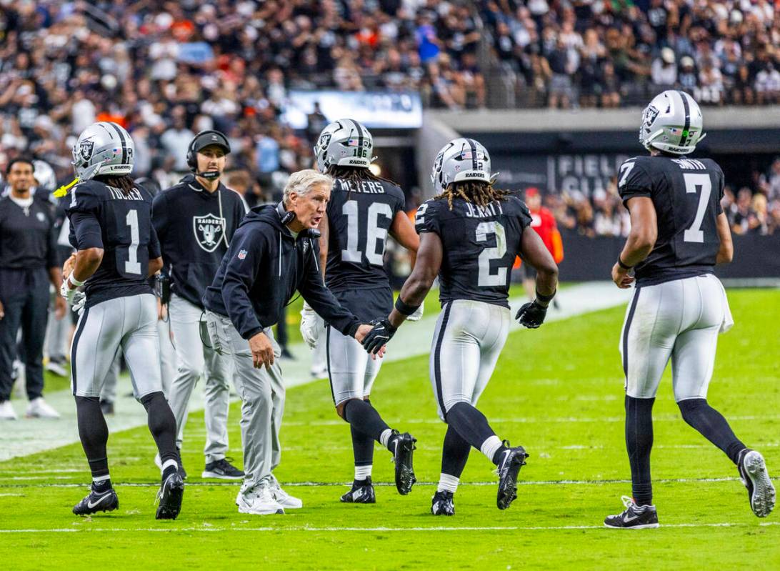 Raiders head coach Pete Carroll congratulates running back Ashton Jeanty (2) on a touchdown run ...