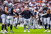 Raiders head coach Pete Carroll congratulates Raiders center Jackson Powers-Johnson (58) and of ...