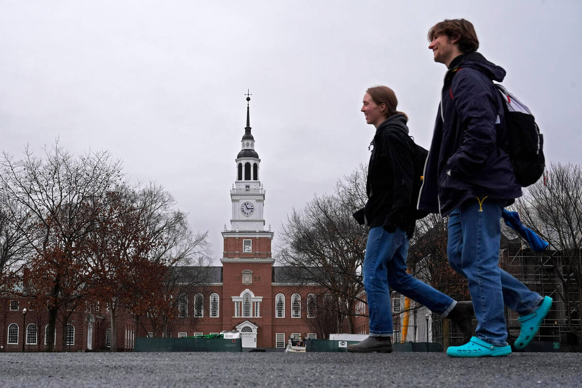 FILE - Students cross the campus of Dartmouth College, March 5, 2024, in Hanover, N.H. (AP Ph ...