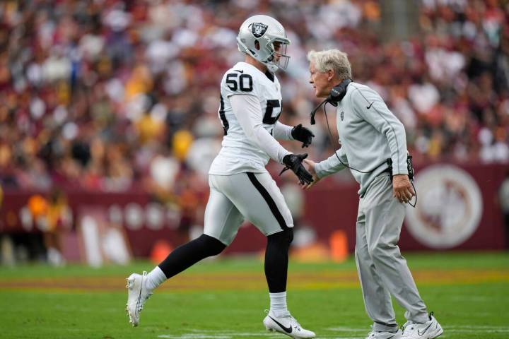 Las Vegas Raiders Pete Carroll shakes hands with long snapper Jacob Bobenmoyer (50) during the ...