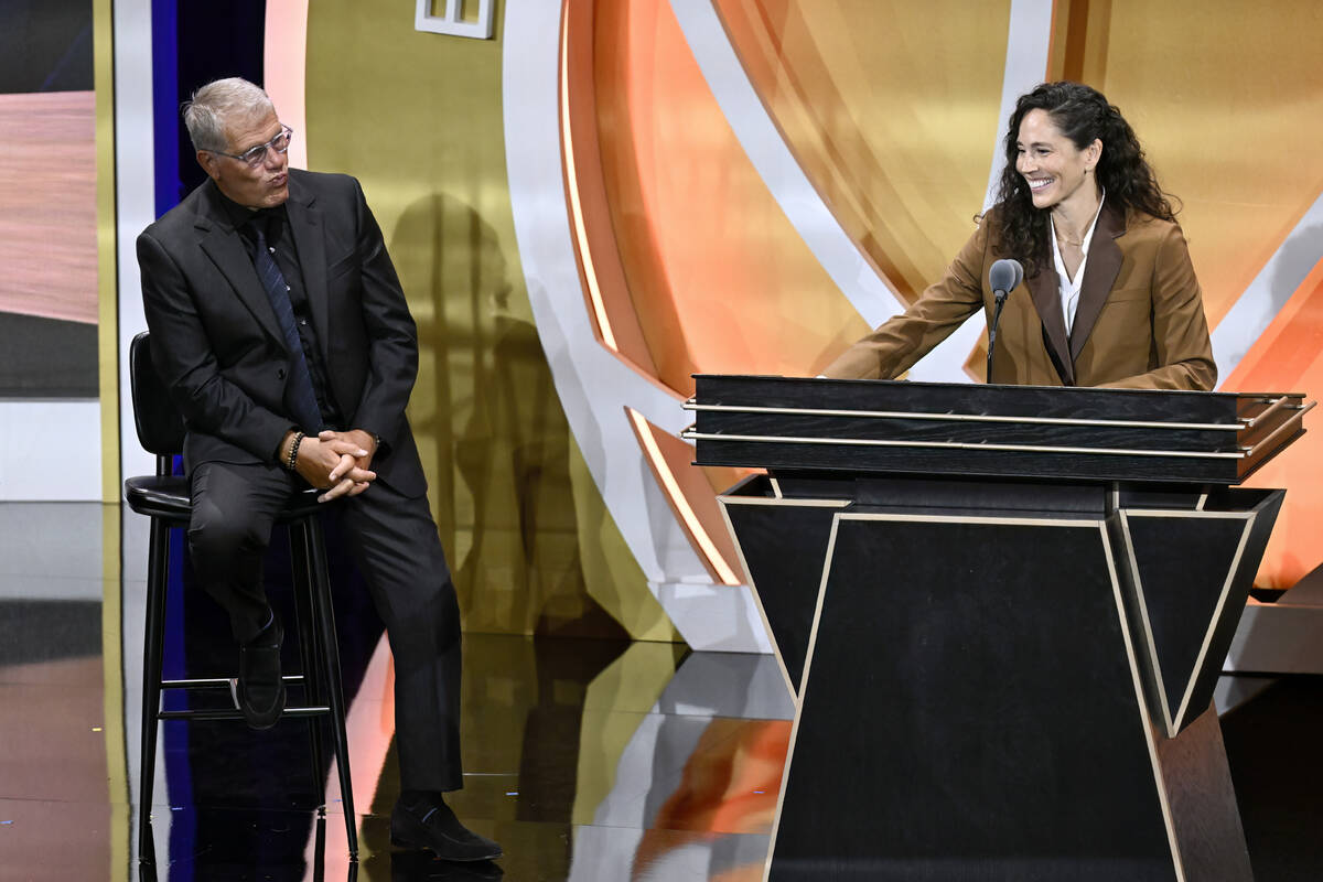 Sue Bird, right, pokes fun of Geno Auriemma, left, during her enshrinement in the Basketball Ha ...