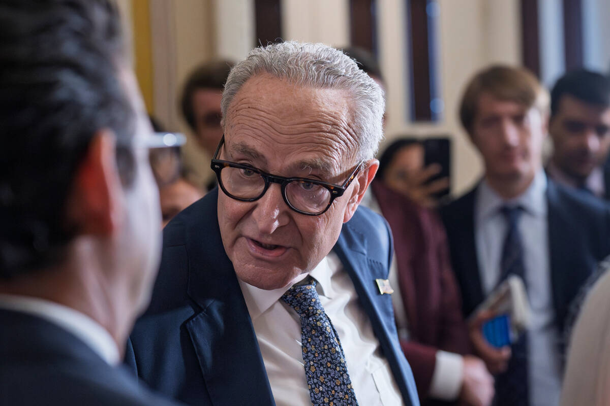 Senate Minority Leader Chuck Schumer, D-N.Y., turns to Sen. Brian Schatz, D-Hawaii, while speak ...