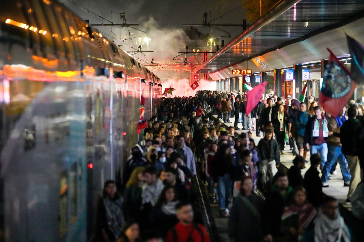 Pro-Palestinian demonstrators flood the rail track at Milan's Cadorna railway station, Ita ...