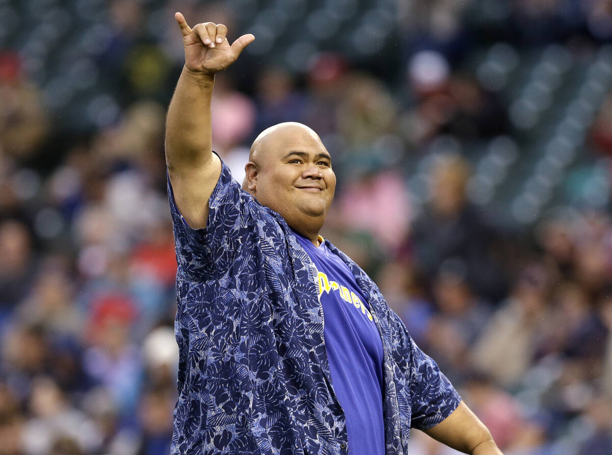 Actor Taylor Wily, also known as Teila Tuli, gestures to fans after throwing out the ceremonial ...