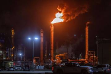 Flames rise from the Chevron refinery in El Segundo, Calif., Thursday, Oct. 2, 2025. (AP Photo/ ...