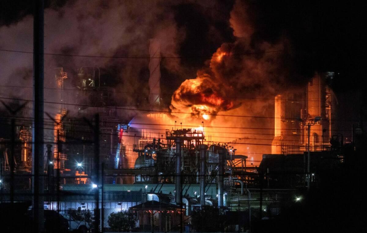 Flames rise from the Chevron refinery in El Segundo, Calif., Thursday, Oct. 2, 2025. (AP Photo/ ...