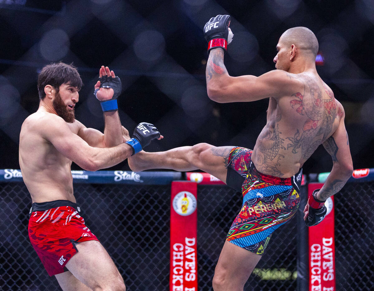 Magomed Ankalaev fends off a kick by Alex Pereira during their light heavyweight fight at UFC 3 ...