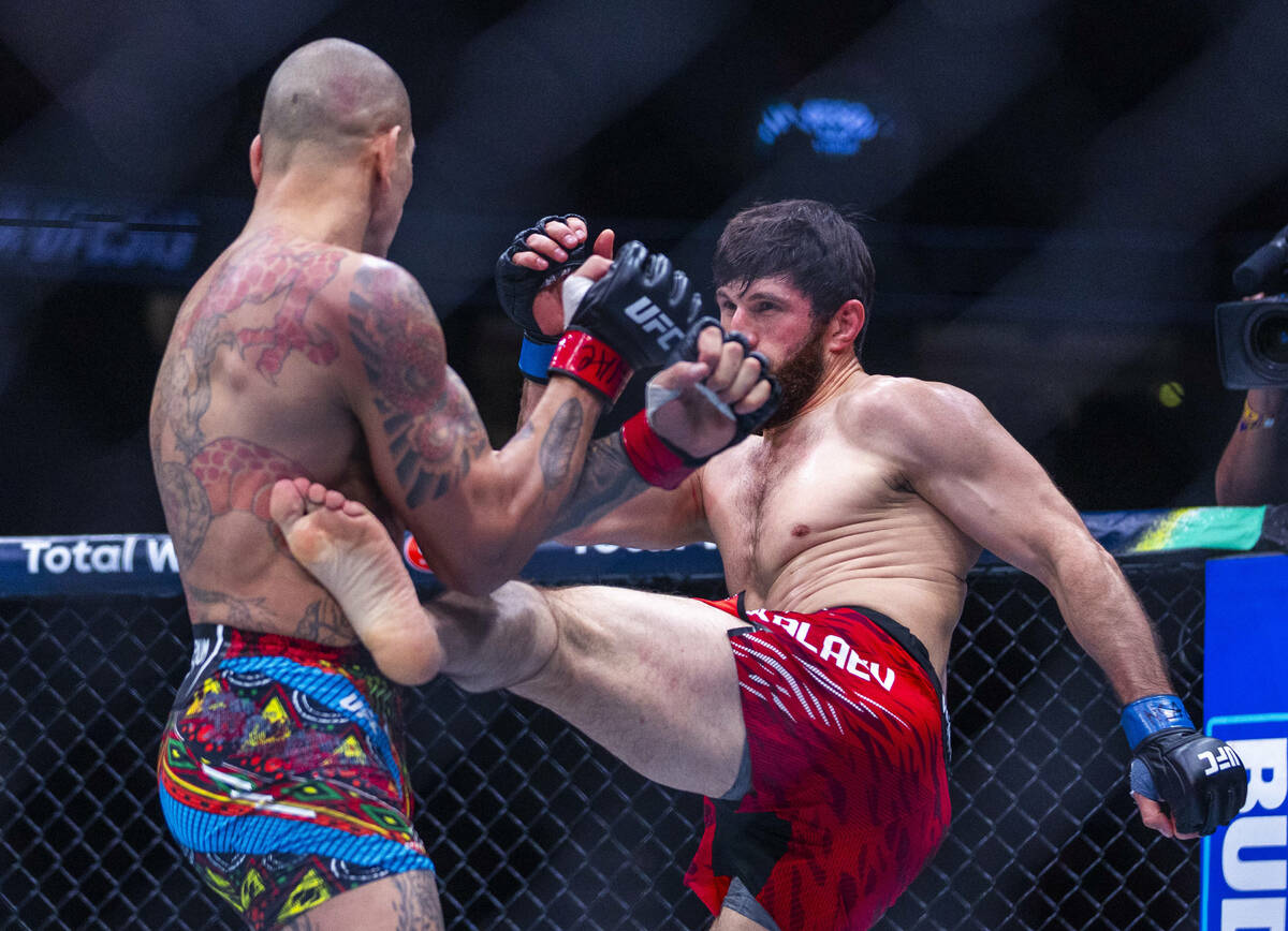 Alex Pereira takes a kick to the side from Magomed Ankalaev during their light heavyweight figh ...