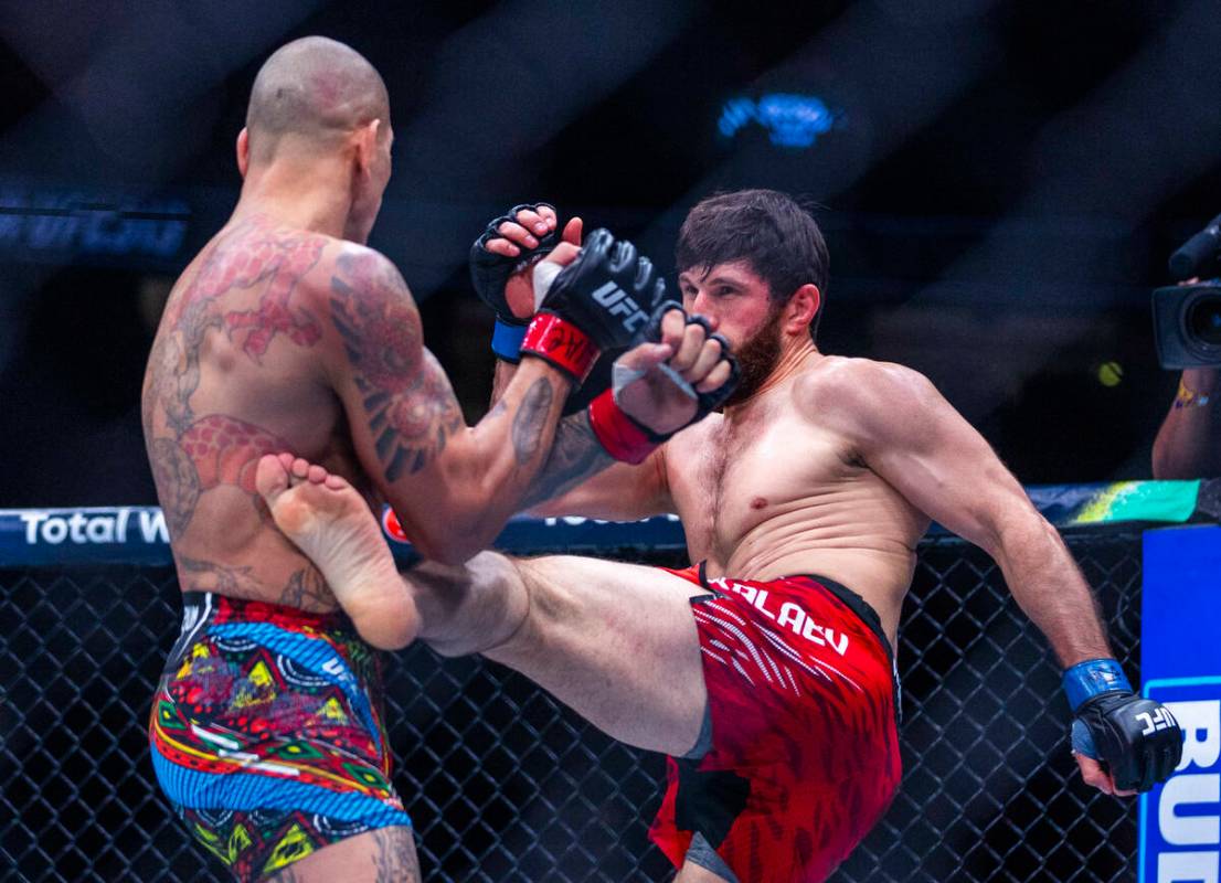 Alex Pereira takes a kick to the side from Magomed Ankalaev during their light heavyweight figh ...