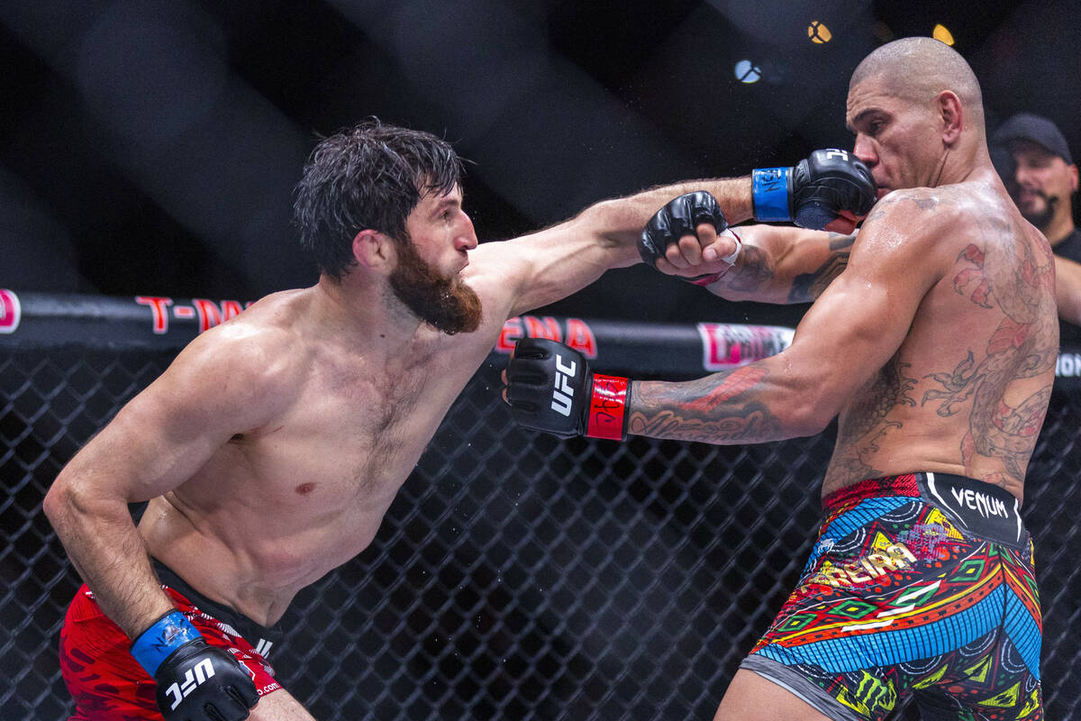 Magomed Ankalaev punches Alex Pereira in the face during their light heavyweight fight at UFC 3 ...