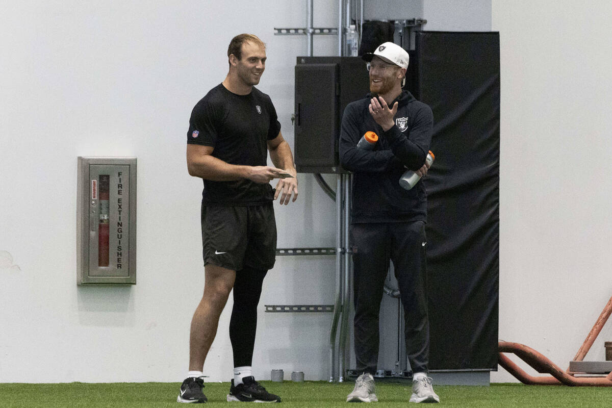 Raiders tight end Brock Bowers, left, and offensive quality control coach Conner McQueen intera ...