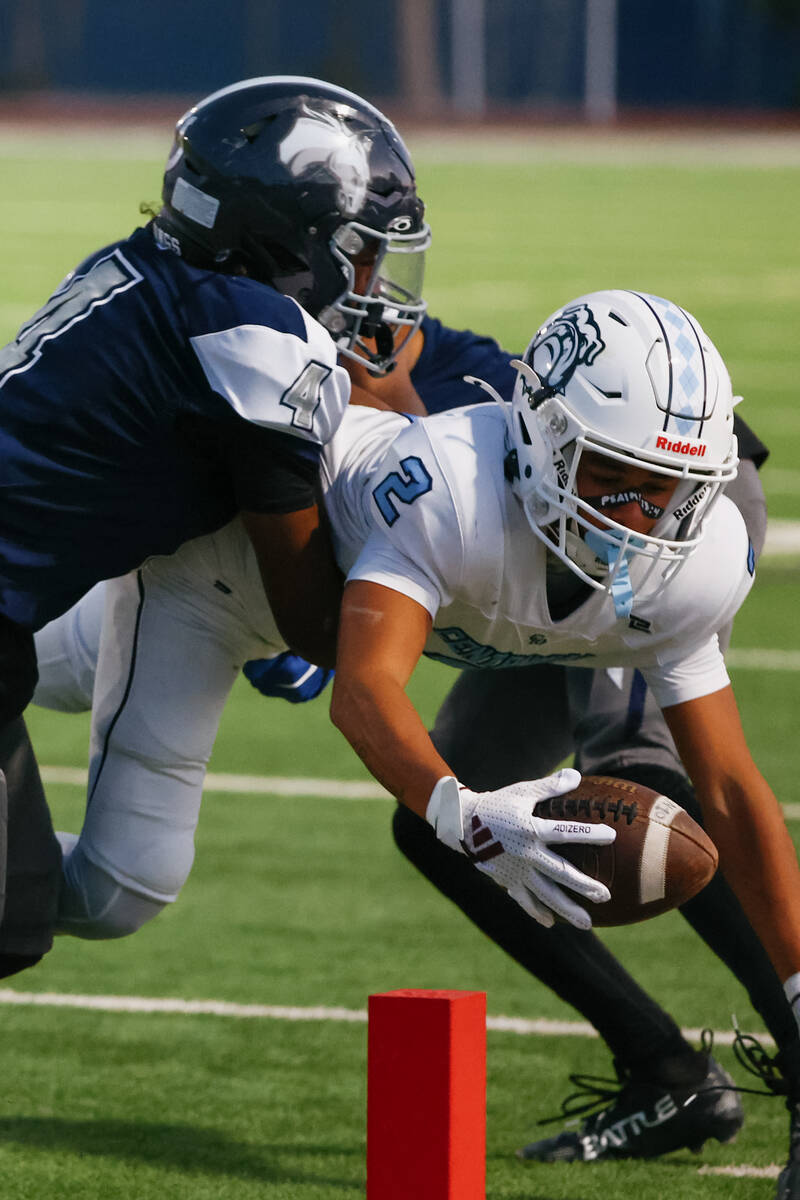 Shadow Ridge’s Xavion Cross (4) stops Centennial’s Jordan Bostick (2) right befor ...