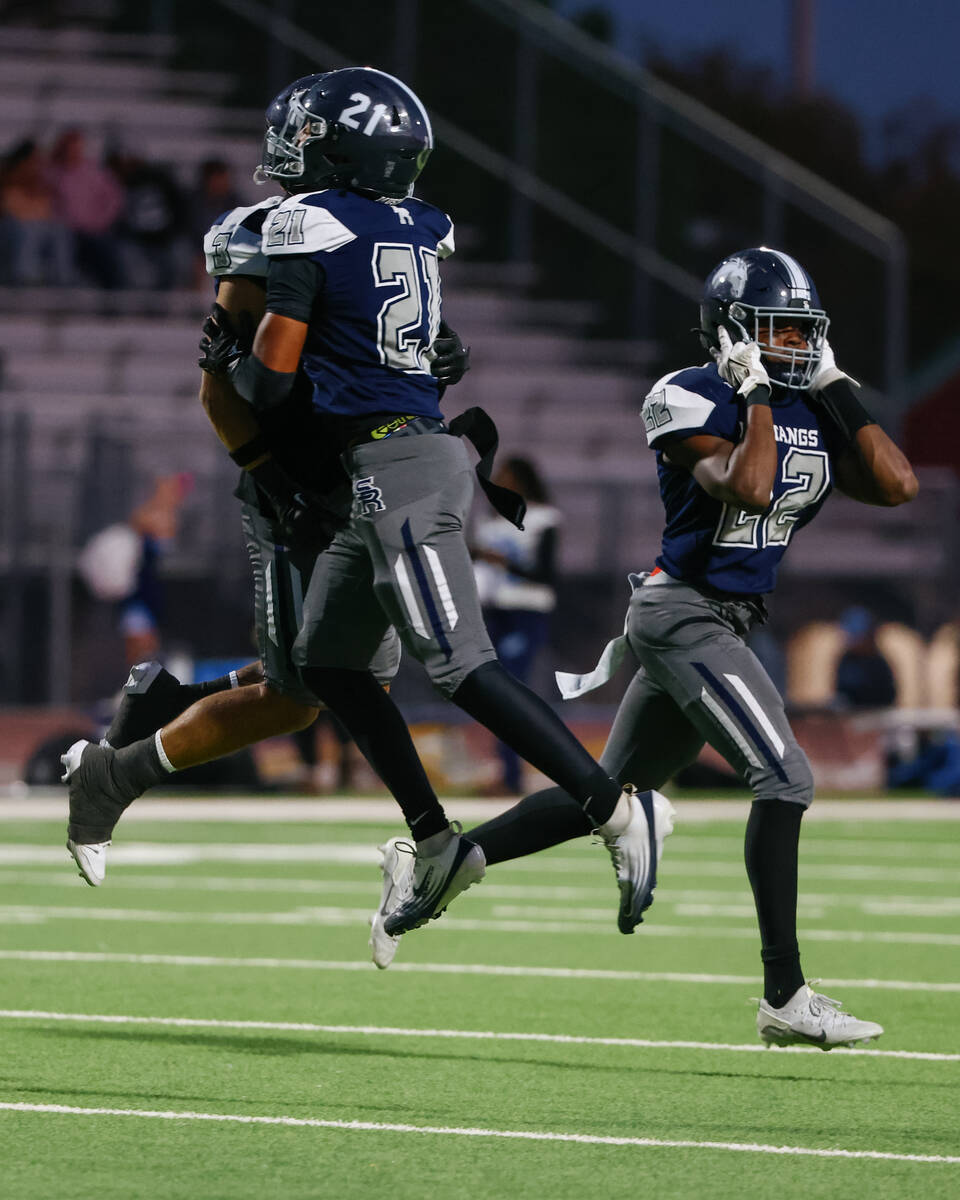 Shadow Ridge’s Charles Parker (21), Ula Cox (3) and Tikari Dillard (22) celebrate a succ ...