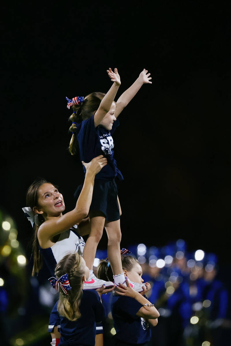 Kindergarteners with Shadow Ridge’s Mini Mustangs do a cheer routine with help from the ...