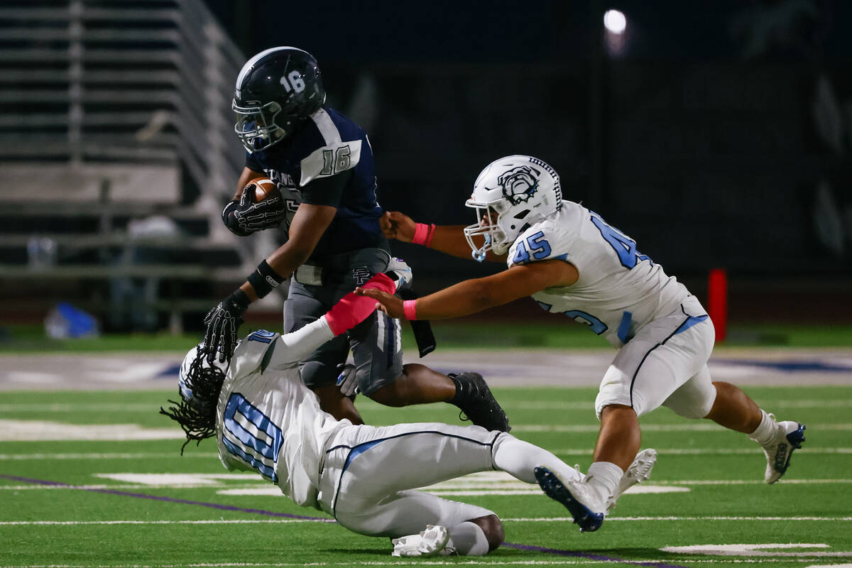 Centennial’s Benjamin Griffin (10) and Kolten Silbernagel (45) bring down Shadow Ridge&# ...