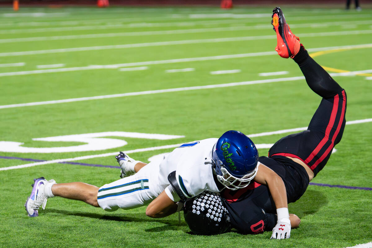 Las Vegas’s Sr. Max Lindaman (80) is brought down by Green Valley’s Bo Hackenbruc ...