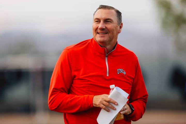 UNLV head football coach Dan Mullen smiles on the sidelines during a high school football game ...