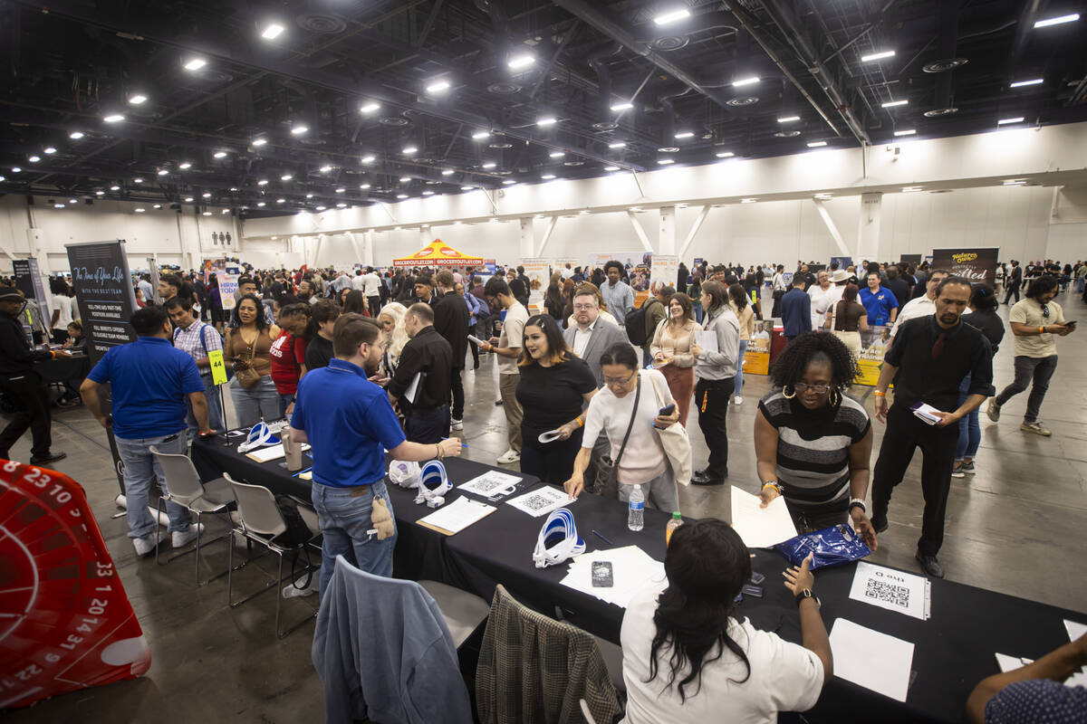 Attendees talk with representatives of Circa and The D during the spring job fair at the Las Ve ...