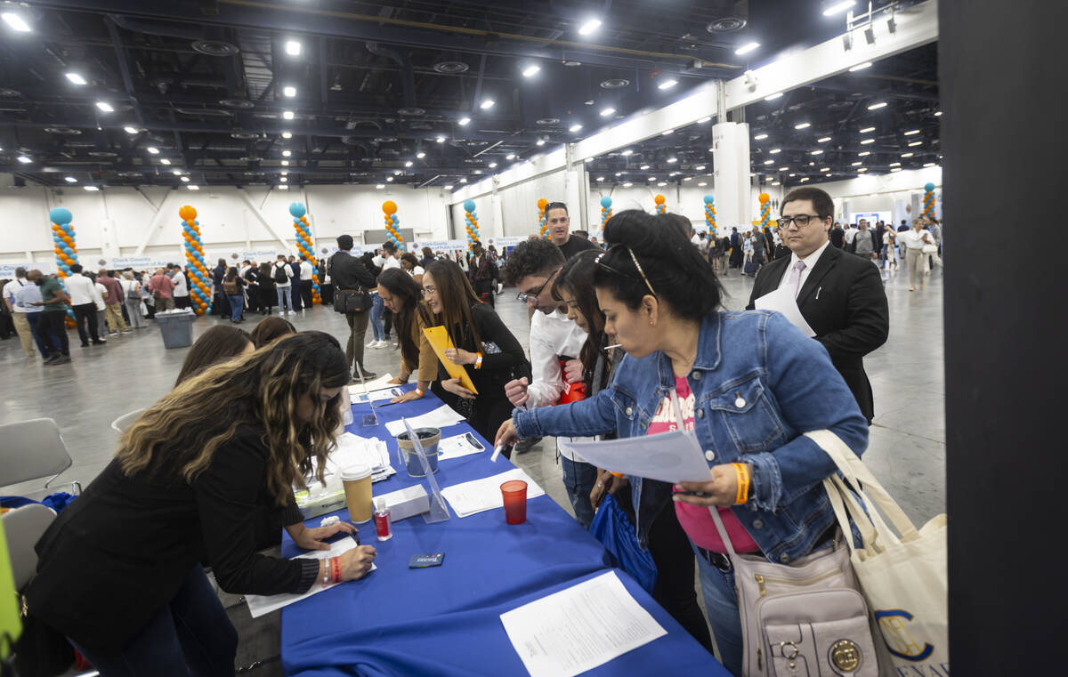 Attendees visit the Tuscany Suites booth during the spring job fair at the Las Vegas Convention ...
