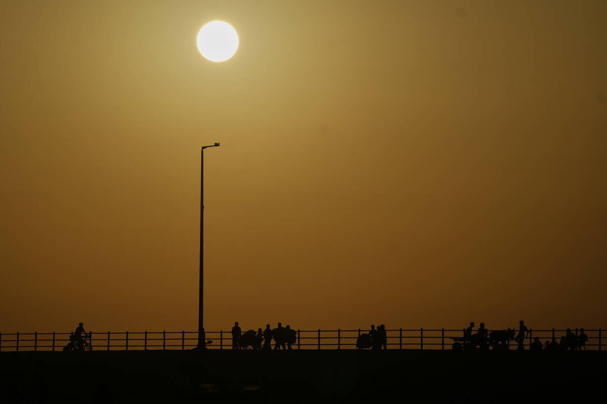 Displaced Palestinians flee northern Gaza carrying their belongings along the coastal road near ...